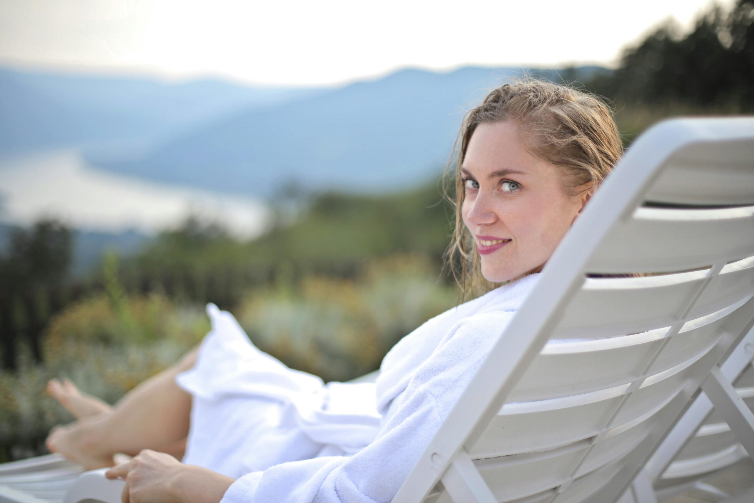 Woman enjoying leisure on a deck with scenic views in Visegrád, Hungary.