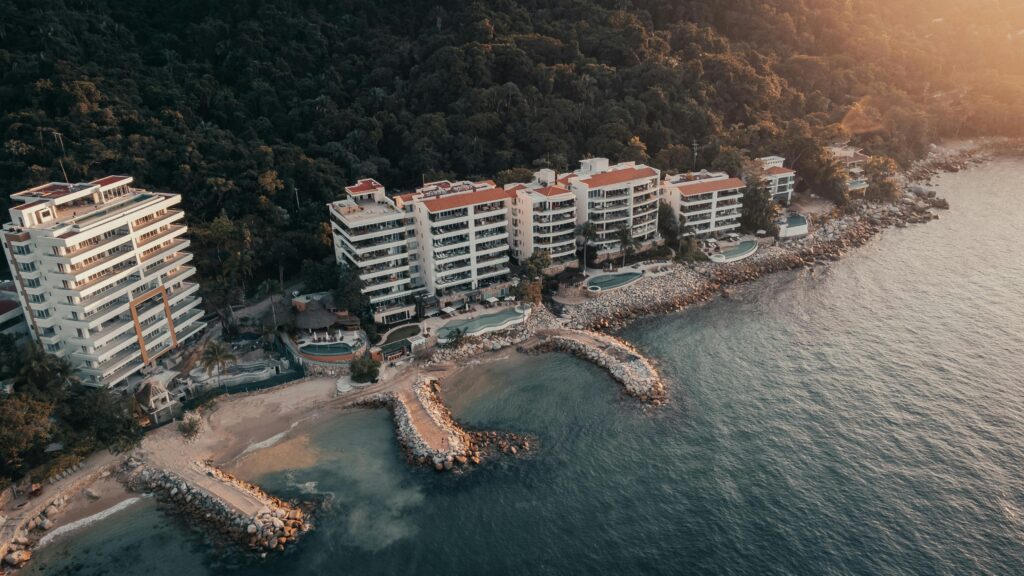 Stunning aerial view of a coastal resort with oceanfront view at sunset.